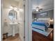 Pedestal sink in half bath leading to main bedroom with blue bedding and a ceiling fan at 2627 Rutherford Way, Charleston, SC 29414
