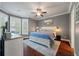 Main bedroom featuring a large window, blue bedding, and wood flooring at 2627 Rutherford Way, Charleston, SC 29414
