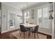 Bright dining area featuring a round table, four chairs, and natural light from shuttered windows at 2627 Rutherford Way, Charleston, SC 29414