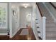 Elegant entryway with hardwood floors, a staircase, and a view into a conveniently located powder room at 2627 Rutherford Way, Charleston, SC 29414