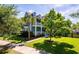Stunning two-story home with a welcoming front porch, lush green lawn, and mature trees at 2627 Rutherford Way, Charleston, SC 29414