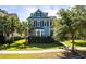 Charming blue two-story home featuring black shutters, lush landscaping, and a well-manicured lawn at 2627 Rutherford Way, Charleston, SC 29414