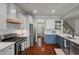 Modern kitchen showcasing white cabinets, stainless steel appliances, and a view into the dining area at 2627 Rutherford Way, Charleston, SC 29414