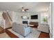 Inviting living room with a cozy fireplace, ceiling fan, and comfortable gray sofa at 2627 Rutherford Way, Charleston, SC 29414