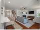 Open-concept living room featuring hardwood floors, a fireplace, and a staircase at 2627 Rutherford Way, Charleston, SC 29414