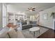 Open-concept living room with hardwood floors flowing into a well-lit kitchen space at 2627 Rutherford Way, Charleston, SC 29414