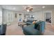Relaxing living room with a comfortable blue sectional sofa, a coffee table, and white framed windows at 2627 Rutherford Way, Charleston, SC 29414