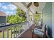 Inviting covered porch with seating, ceiling fans, and scenic views of lush greenery at 2627 Rutherford Way, Charleston, SC 29414