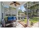 Cozy screened porch with comfortable seating, ceiling fan, and views of the lush backyard at 2627 Rutherford Way, Charleston, SC 29414
