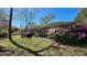 Backyard featuring outdoor seating and grilling area with brick home exterior and leafy azalea bushes at 2636 Elissa Dr, Charleston, SC 29414