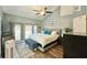 Cozy main bedroom with ceiling fan, walk-out balcony, and decorative rug at 2636 Elissa Dr, Charleston, SC 29414