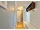 Hallway with hardwood floors, shiplap accent wall, and a bench for storage at 2636 Elissa Dr, Charleston, SC 29414