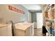Laundry room with washer, dryer, storage shelves and a utility sink at 2636 Elissa Dr, Charleston, SC 29414