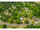 A picturesque aerial view of homes in a quiet neighborhood surrounded by lush green trees and well-manicured lawns at 285 Roosevelt Dr, Saint Stephen, SC 29479