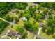 An aerial view of a neighborhood featuring tree-lined streets and well-maintained homes with lush landscaping at 285 Roosevelt Dr, Saint Stephen, SC 29479