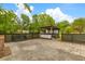 Large fenced backyard featuring an outdoor grill area with brick and concrete patio at 285 Roosevelt Dr, Saint Stephen, SC 29479
