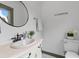 Elegant bathroom featuring a sleek black round mirror, marble countertop, and stylish fixtures at 285 Roosevelt Dr, Saint Stephen, SC 29479