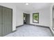 Bedroom with white and gray trim, white marble-look flooring, and large windows at 285 Roosevelt Dr, Saint Stephen, SC 29479