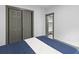 Bedroom with an open closet and updated gray sliding closet doors, featuring a top view of a neatly made bed at 285 Roosevelt Dr, Saint Stephen, SC 29479