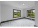 Bedroom featuring white walls and marble-look floors and windows with views of the lawn at 285 Roosevelt Dr, Saint Stephen, SC 29479