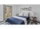 Serene bedroom featuring a large window overlooking trees, neutral walls and carpet, and stylish lamps at 285 Roosevelt Dr, Saint Stephen, SC 29479