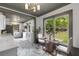 Bright dining nook with stylish furniture and a view into the kitchen and backyard at 285 Roosevelt Dr, Saint Stephen, SC 29479