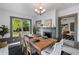 Dining room features a wooden table, a decorative fireplace, and a window to the yard at 285 Roosevelt Dr, Saint Stephen, SC 29479
