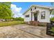 Side view of white home featuring concrete patio, brick foundation, and landscaped yard at 285 Roosevelt Dr, Saint Stephen, SC 29479