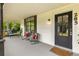 Cozy front porch with comfortable seating, plants, and a view of the well-maintained front yard at 285 Roosevelt Dr, Saint Stephen, SC 29479