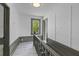 Light-filled upstairs hallway with wood railing and view through window to landscaped yard at 285 Roosevelt Dr, Saint Stephen, SC 29479