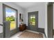 Hallway featuring a window, gray trim, and a view of the outdoors, complemented by decor at 285 Roosevelt Dr, Saint Stephen, SC 29479