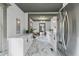 Modern kitchen with white cabinets, stainless steel appliances, and marble tile flooring at 285 Roosevelt Dr, Saint Stephen, SC 29479