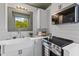 Kitchen area features a farmhouse sink, white cabinetry, and stainless appliances at 285 Roosevelt Dr, Saint Stephen, SC 29479