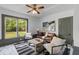 Bright living room with leather sofa, stylish chairs, and a striped rug at 285 Roosevelt Dr, Saint Stephen, SC 29479