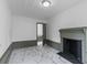 Living room with white and gray trim, white marble-look flooring, fireplace, and open doorway at 285 Roosevelt Dr, Saint Stephen, SC 29479