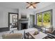 Cozy living room with a fireplace, marble floors, and a view into the dining room at 285 Roosevelt Dr, Saint Stephen, SC 29479