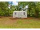 A metal shed with double-hung windows sits amid a spacious, partially wooded yard at 285 Roosevelt Dr, Saint Stephen, SC 29479