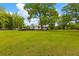 Expansive front yard featuring mature trees, complemented by a charming home in the background at 285 Roosevelt Dr, Saint Stephen, SC 29479