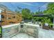 Outdoor kitchen and lounge area featuring a built-in grill and comfortable patio seating at 2962 Clearwater Dr, Mount Pleasant, SC 29466
