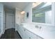 Bright bathroom with double vanity sinks, white cabinets, and tile floors and mirrors at 2962 Clearwater Dr, Mount Pleasant, SC 29466