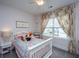 Charming bedroom with a white bed, soft decor and natural light from the window at 2962 Clearwater Dr, Mount Pleasant, SC 29466