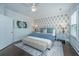Comfortable bedroom with a queen bed, decorative accent wall, and neutral-toned decor at 2962 Clearwater Dr, Mount Pleasant, SC 29466