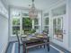 Cozy dining area featuring a chandelier, dark wood table, bench seating, and views of the backyard at 2962 Clearwater Dr, Mount Pleasant, SC 29466