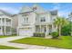 Charming two-story home with manicured lawn, a covered porch, and an attached two-car garage at 2962 Clearwater Dr, Mount Pleasant, SC 29466