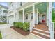 Inviting front porch with a red door, classic columns, and a teal-painted ceiling for added charm at 2962 Clearwater Dr, Mount Pleasant, SC 29466