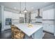 Bright kitchen with white cabinets, stainless steel appliances, large island with seating and pendant lighting at 2962 Clearwater Dr, Mount Pleasant, SC 29466
