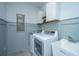 Well-lit laundry room featuring modern washer and dryer, cabinets, and a utility sink at 2962 Clearwater Dr, Mount Pleasant, SC 29466