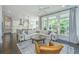 Bright living room with hardwood floors, large windows, white sectional, and open to the kitchen at 2962 Clearwater Dr, Mount Pleasant, SC 29466
