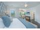 Bright main bedroom featuring a sitting area, ceiling fan, decorative accent wall and hardwood floors at 2962 Clearwater Dr, Mount Pleasant, SC 29466