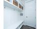 White mudroom featuring built-in shelving, storage baskets, hooks, a bench and a paneled door at 2962 Clearwater Dr, Mount Pleasant, SC 29466